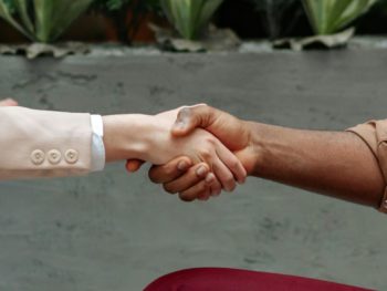 Handshake symbolizing a strategic partnership agreement between two organizations, representing collaboration and mutual commitment.